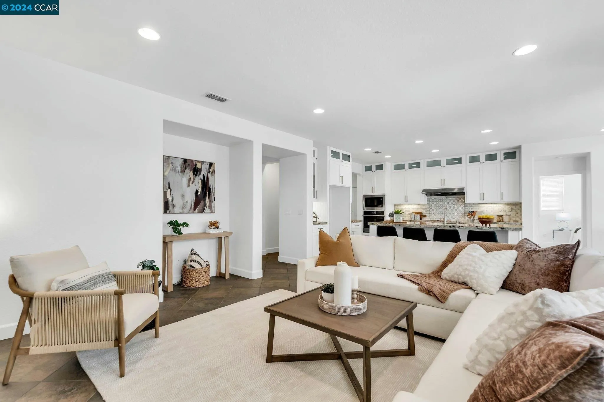 Staged living room in Concord home featuring modern furnishings and warm decor
